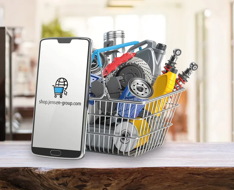 Smartphone vor Korb mit Werkzeug und Ersatzteilen