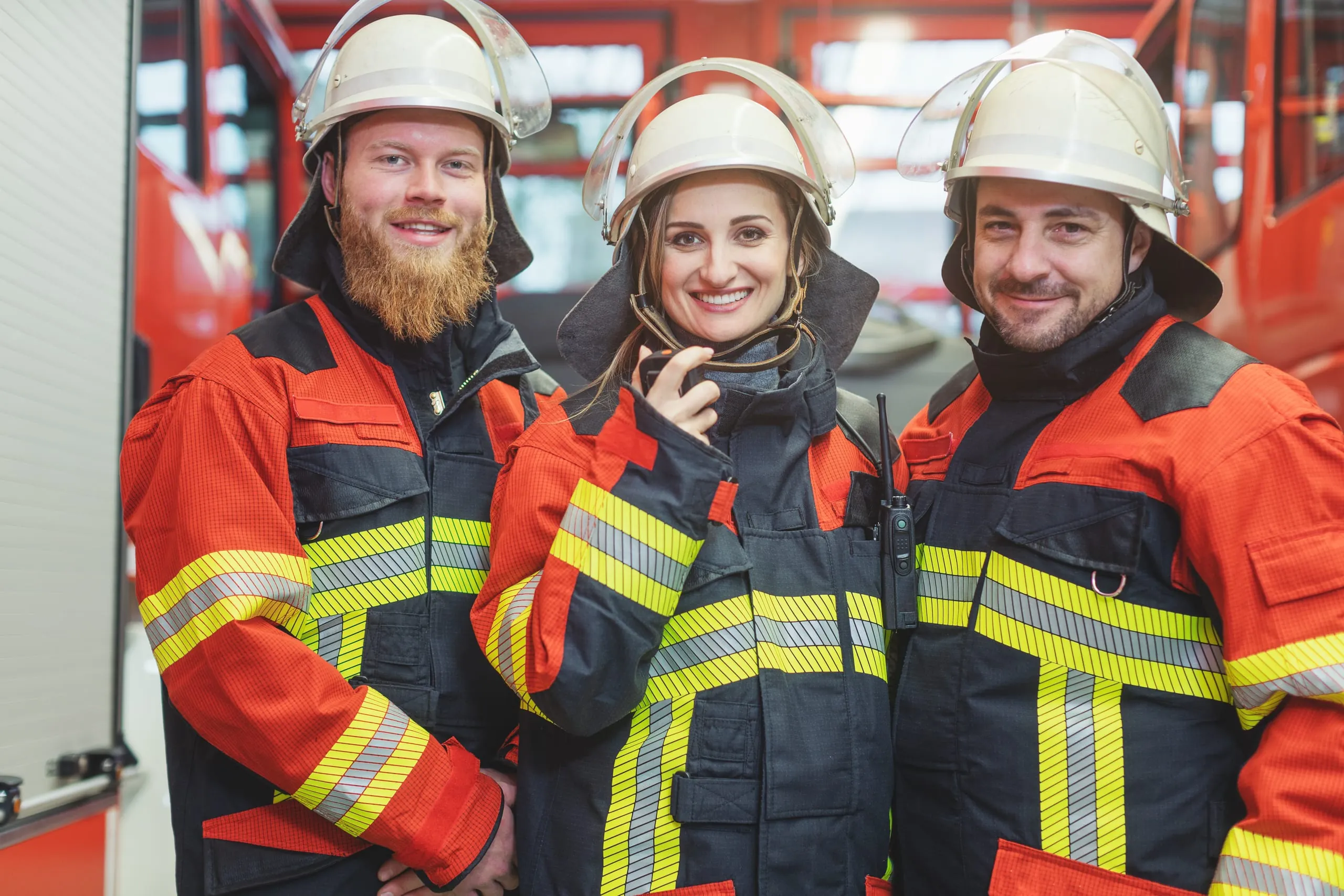 Das Foto zeigt drei Feuerwehrkräfte in Einsatzmontur.