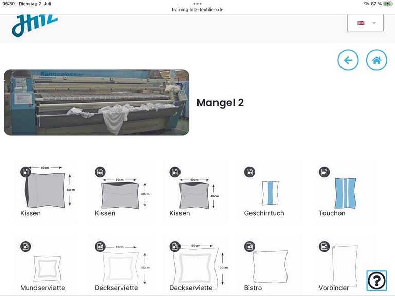 Worxcamera zeigt online ein Foto der Mangel und Piktogramme der Textilien, die damit bearbeitet werden.